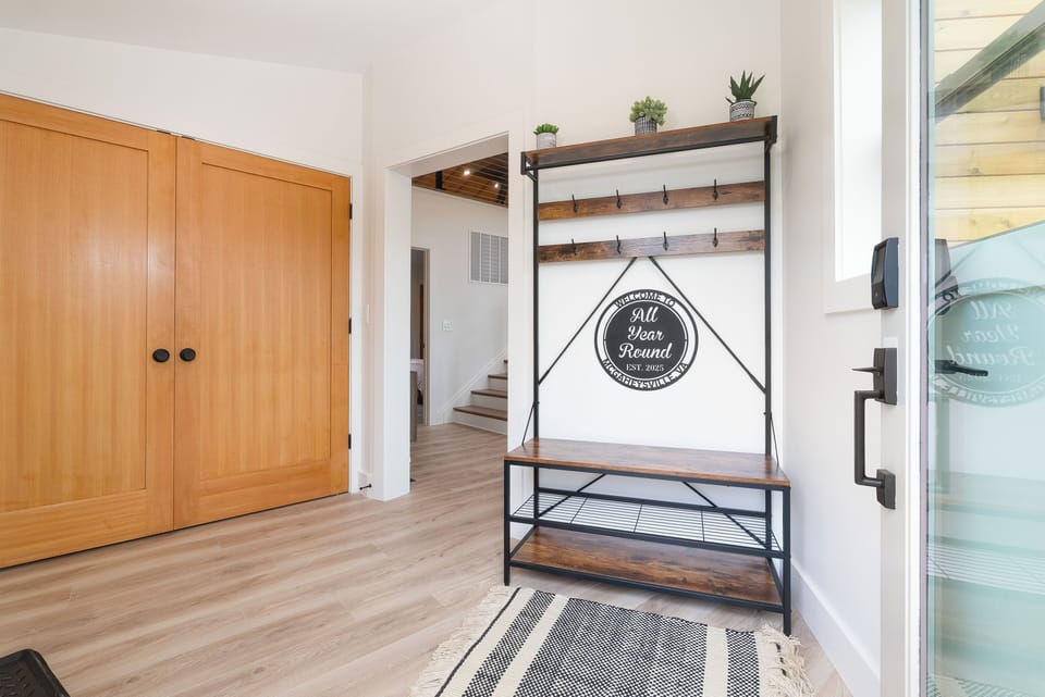 Entryway with laundry closet for guest use.