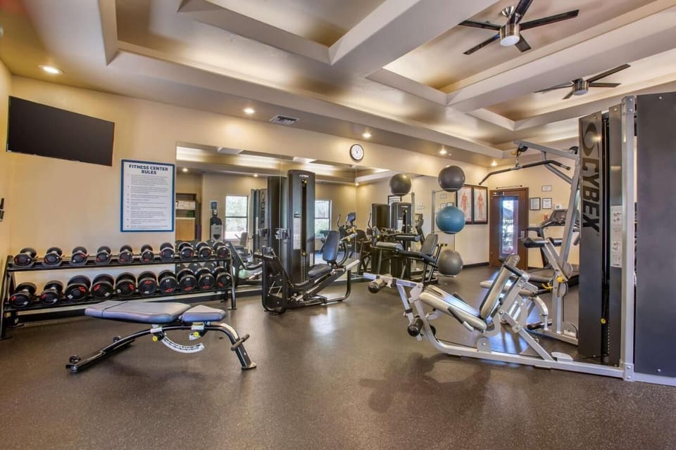 Energize your day with a bright gym and free weights.