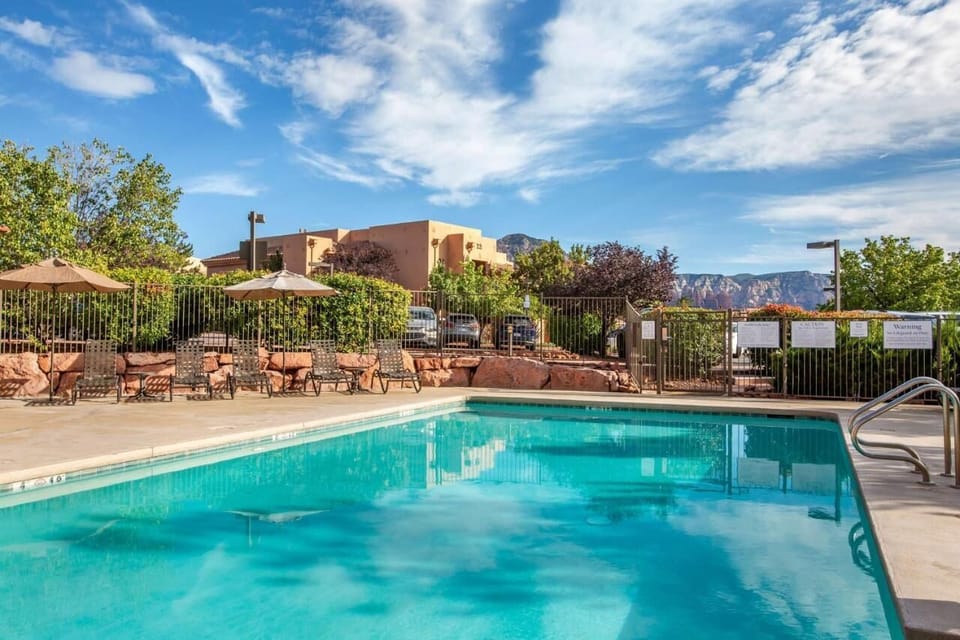 Dive into refreshing waters with scenic red-rock skies overhead.