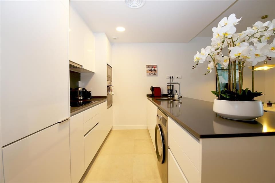 Modern open kitchen in this property is fully equipped with all the appliances