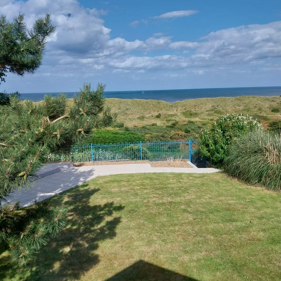 View of the sea across the lawn and terrace.