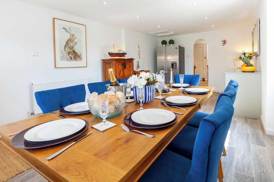 Dining room seats 8, leading to the Kitchen. Doors to front garden & side patio