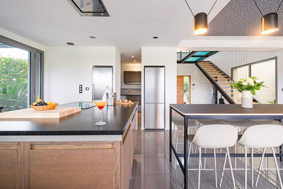 Stylish kitchen with high-end appliances and breakfast bar, made for sharing meals and moments.