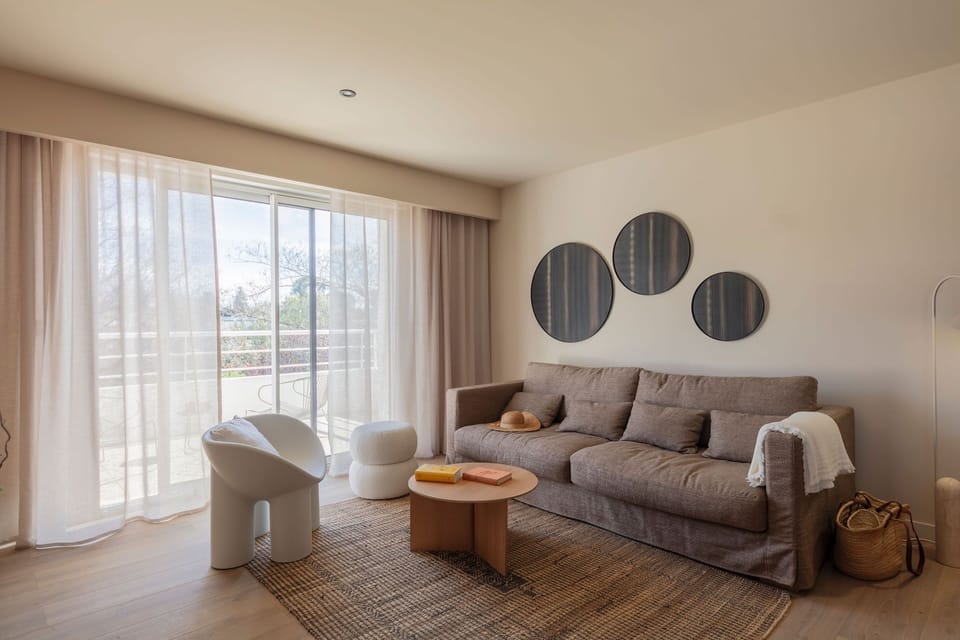 Cozy living space with modern furnishings and direct terrace access—perfect for lounging or casual dining.