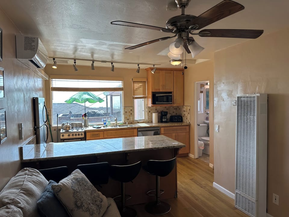Living room and kitchen with bathroom in far right.  Detached bath is convenient