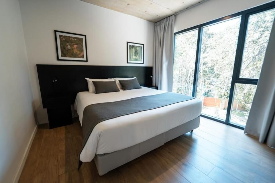 Unwind in a sunlit bedroom with soothing garden views.