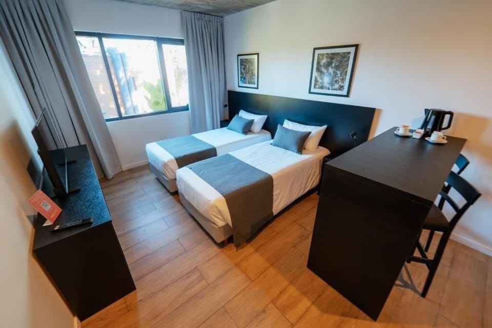 Relax in a spacious twin room designed for easy comfort.
