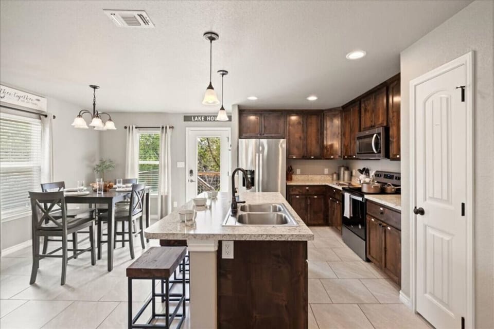 Cook, dine, and connect in this fully stocked kitchen and open dining space.