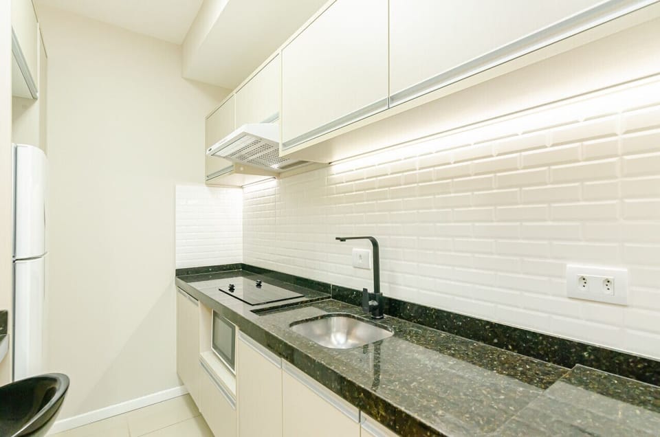 Cozinha - Exaustor, cooktop, pia e armários.