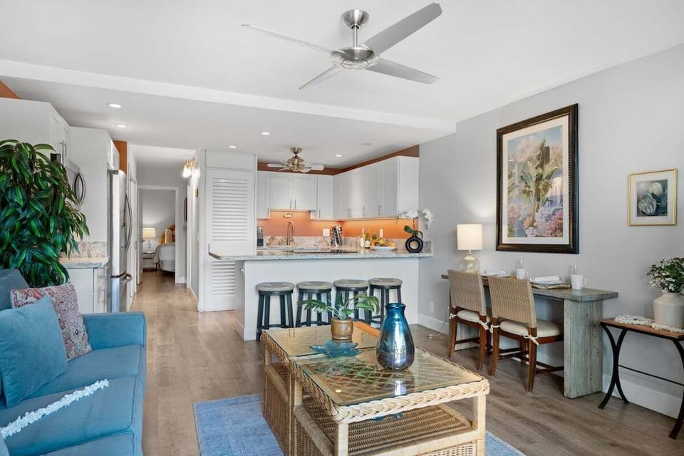 Spacious open-concept living room with seamless flow to kitchen and dining