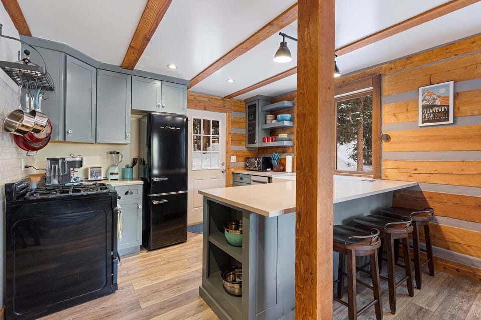 Kitchen: Main floor, drip coffee maker, Keurig, toaster, cooking utensils, tableware