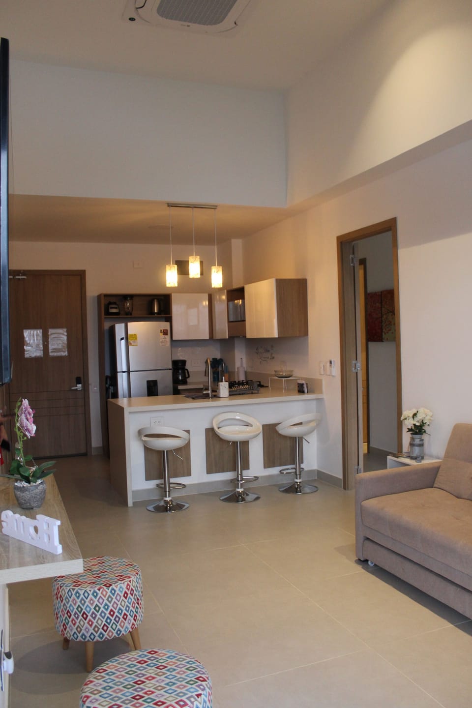 View of the living room and fully equipped kitchen