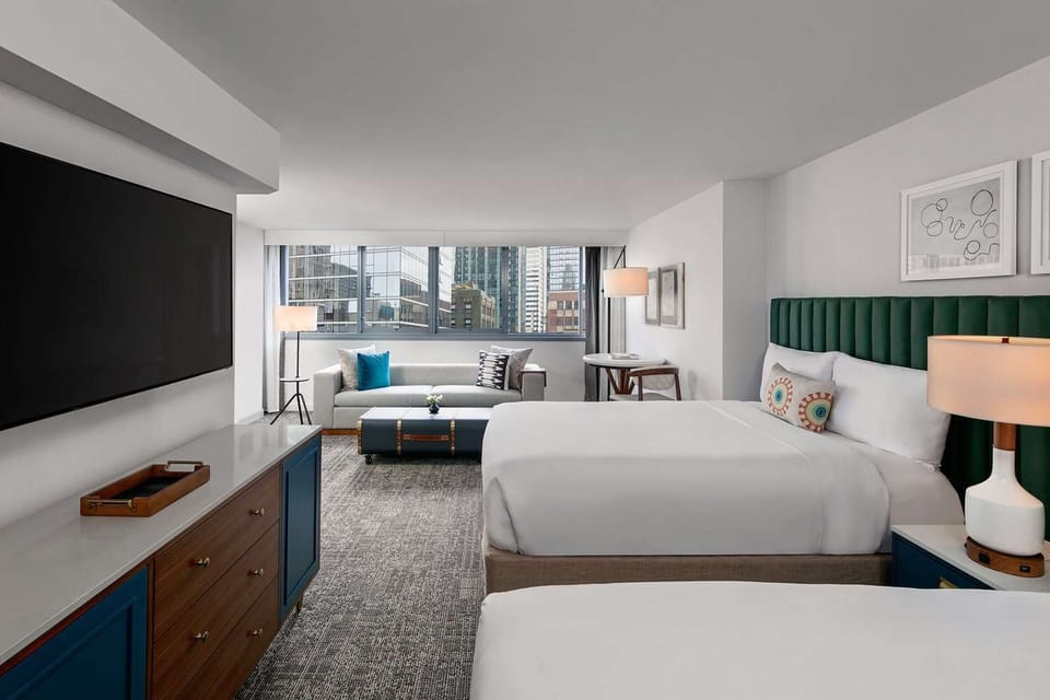 Settle into a spacious room with skyline views and plush beds.