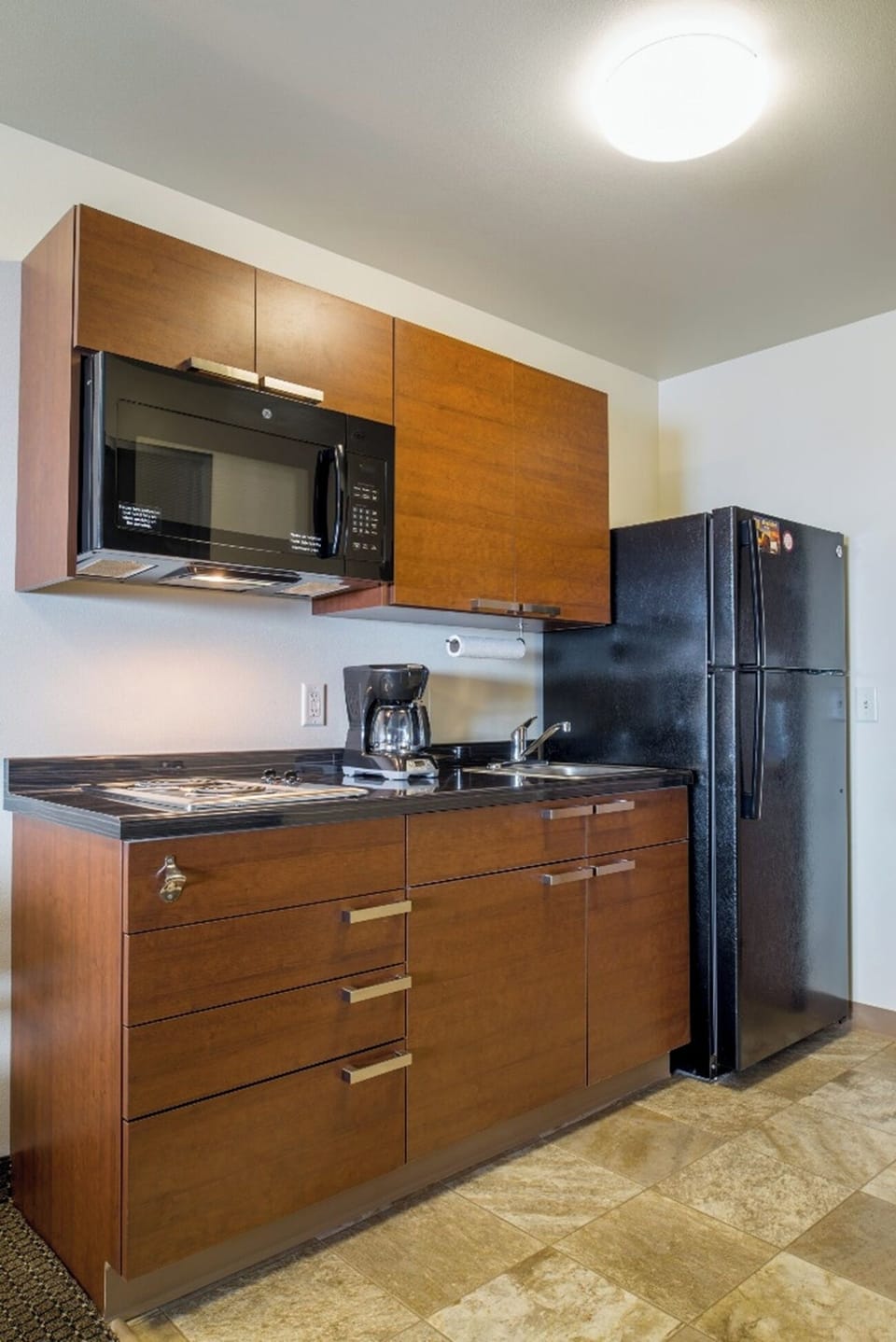 Enjoy an easy stay with kitchenette convenience beside your bed.