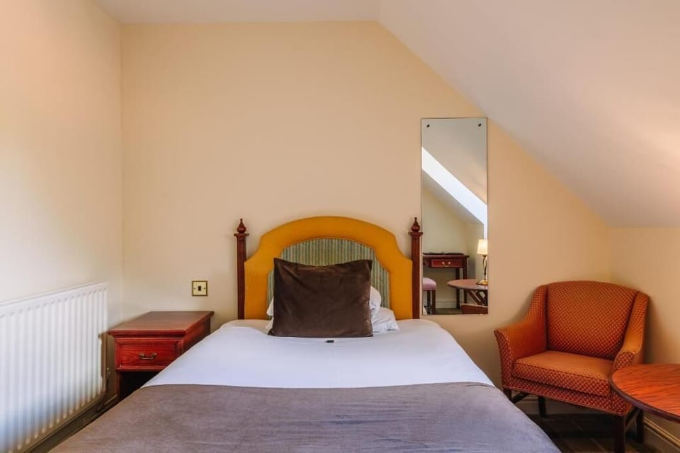 Drift off comfortably in crisp linens under warm, restful light.
