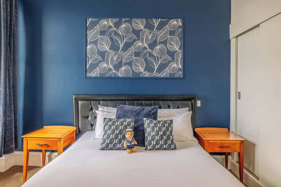 Relax against a padded headboard with soft, layered pillows.
