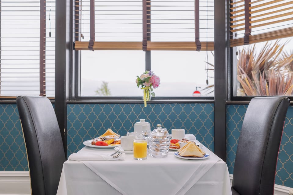 Savor a continental breakfast at a crisp, linen-dressed table.