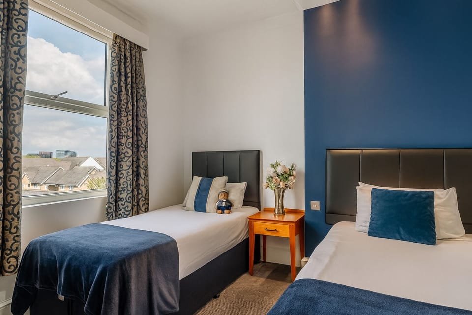 Wake up refreshed beside sunny windows and crisp blue accents