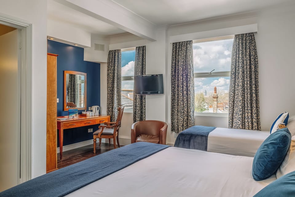 Relax into a spacious king bed against calming blue walls