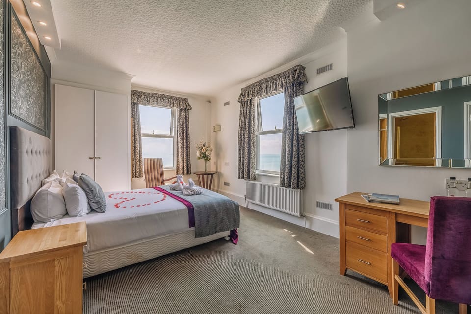 Stretch out in a spacious room with TV and writing desk.