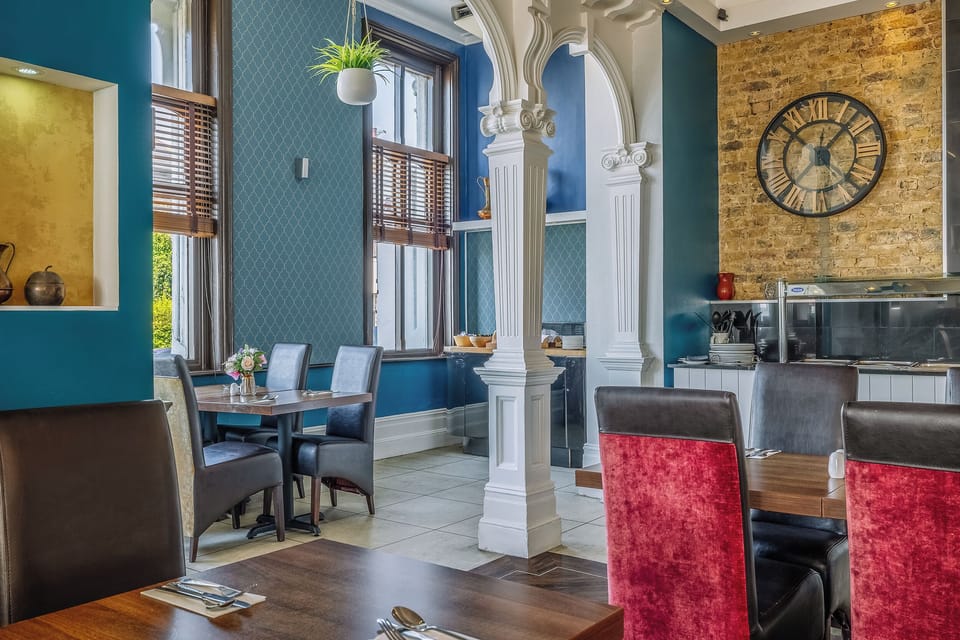 Settle in for relaxed meals beneath elegant archways.
