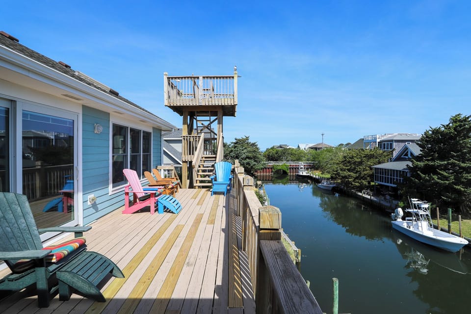 Relax on your private waterfront deck with colorful Adirondack chairs while enjoying peaceful canal views and your own observation tower.