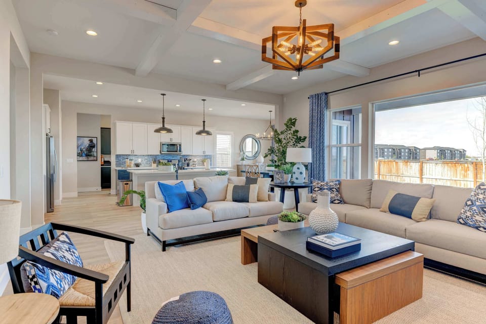 Living Room: Relax in this spacious, light-filled living room with a cozy fireplace, mounted TV, and plush seating — perfect for movie nights or laid-back mornings.