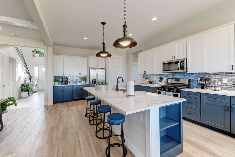 Kitchen: Cook in style with modern stainless steel appliances, chic cabinetry, and a beautiful backsplash that ties it all together.