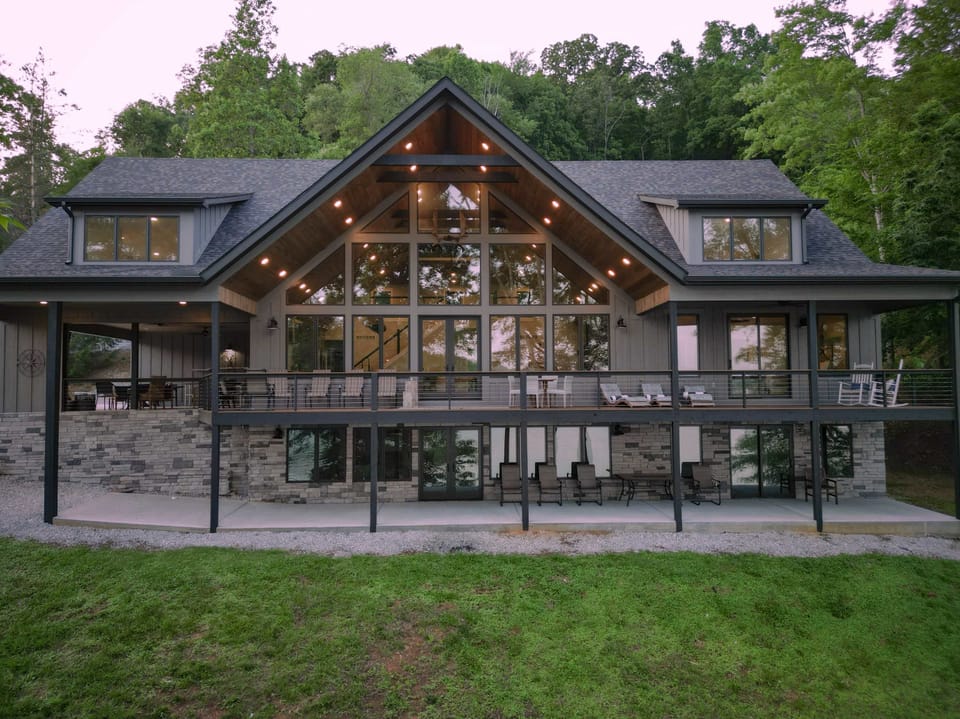 The expansive deck out the front overlooking the water of Norris Lake. Plenty of outdoor seating, and a propane grill all set up and ready to go for guests to use. 