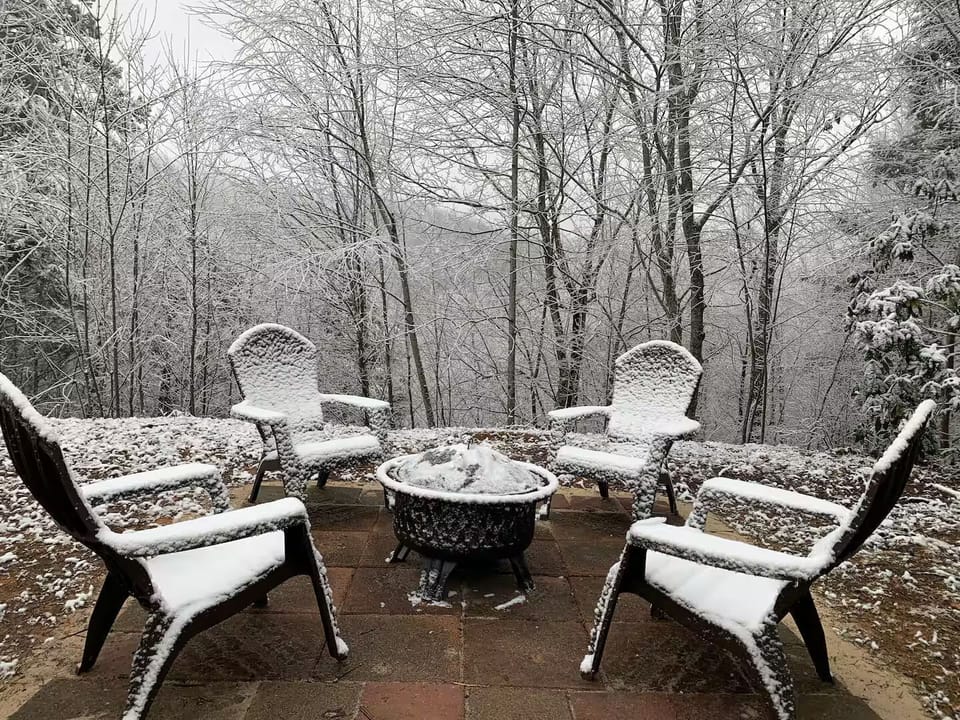 Gather 'round the fire pit and enjoy winter's charm amidst snowy serenity!