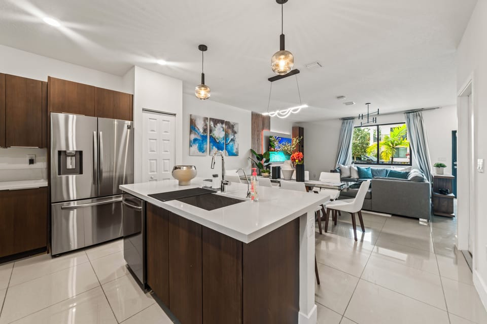The fully equipped kitchen seamlessly flows into the dining area