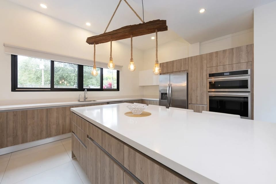 Bright modern kitchen with island seating for four guests.
