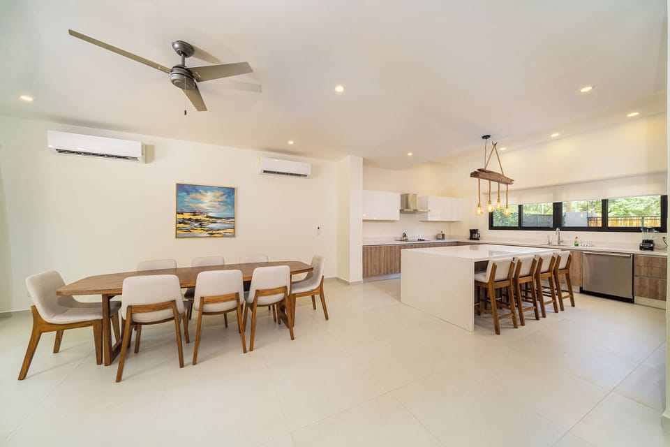 Guests can dine indoors at the kitchen counter or gather around the dining table