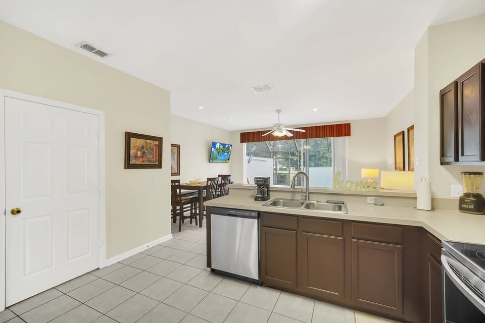 Spacious Open-Concept Kitchen and Dining Area with Pool Views