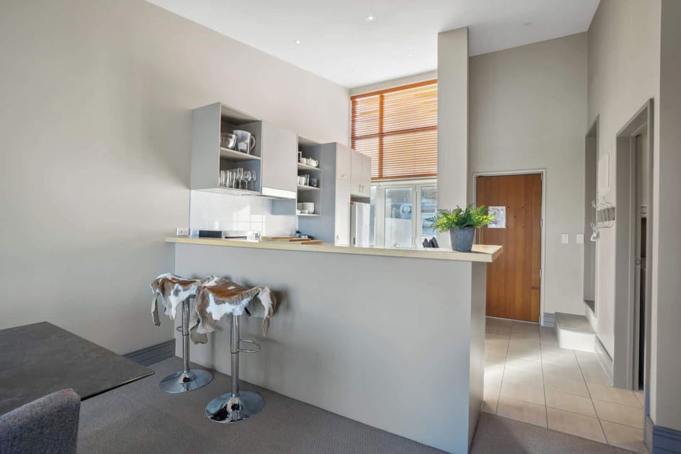 Modern kitchen with breakfast bar seating, perfect for casual dining or morning coffee.
