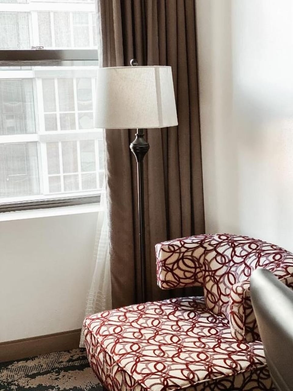 Unwind by the window with a cozy reading chair.