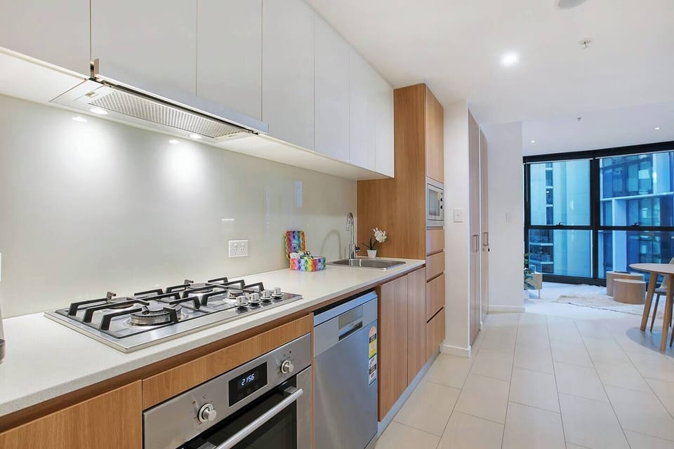 Whether brewing a morning espresso or preparing dinner for two, this compact yet efficient kitchen is fully equipped with an oven, dishwasher, and full-sized fridge.
