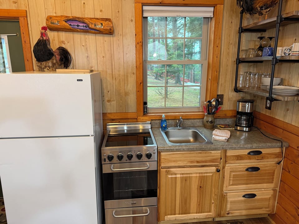 Your cozy kitchen features everything you need to whip up home-cooked meals, from the stove and full-sized fridge to charming country décor. Enjoy views of the peaceful green surroundings right from your window.