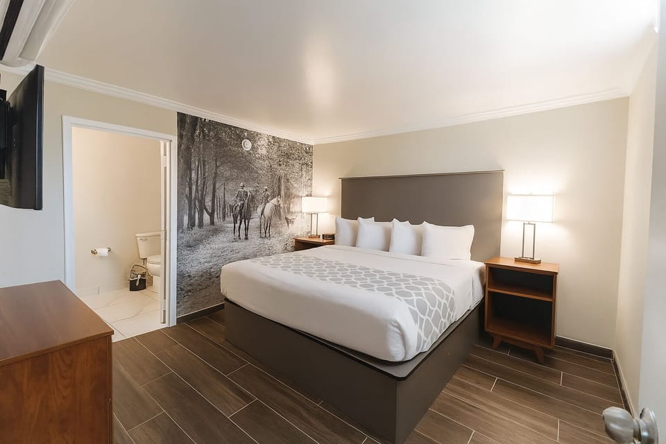 Unwind in a plush king bed with calming artwork.