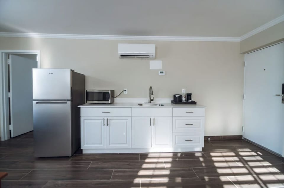 Prepare quick meals with fridge, microwave, and sleek sink.
