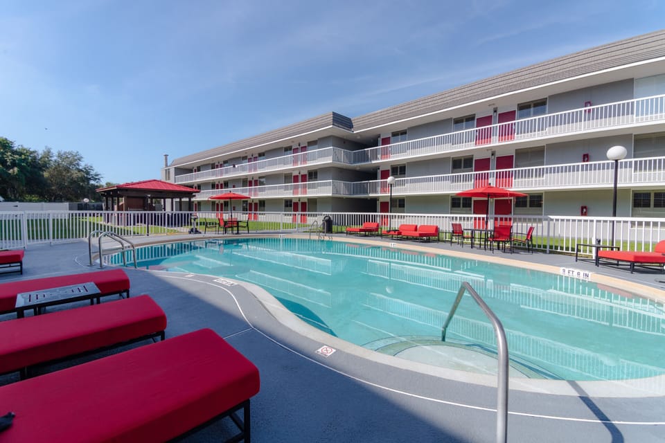 Dive into sunshine by the sparkling pool and loungers.