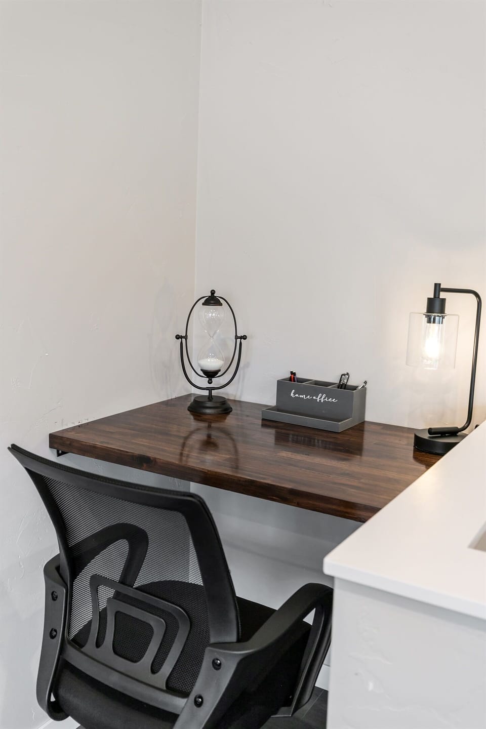 A comfy office chair and cozy setup make this little nook the perfect spot to work, plan your day, or just relax with a good book.