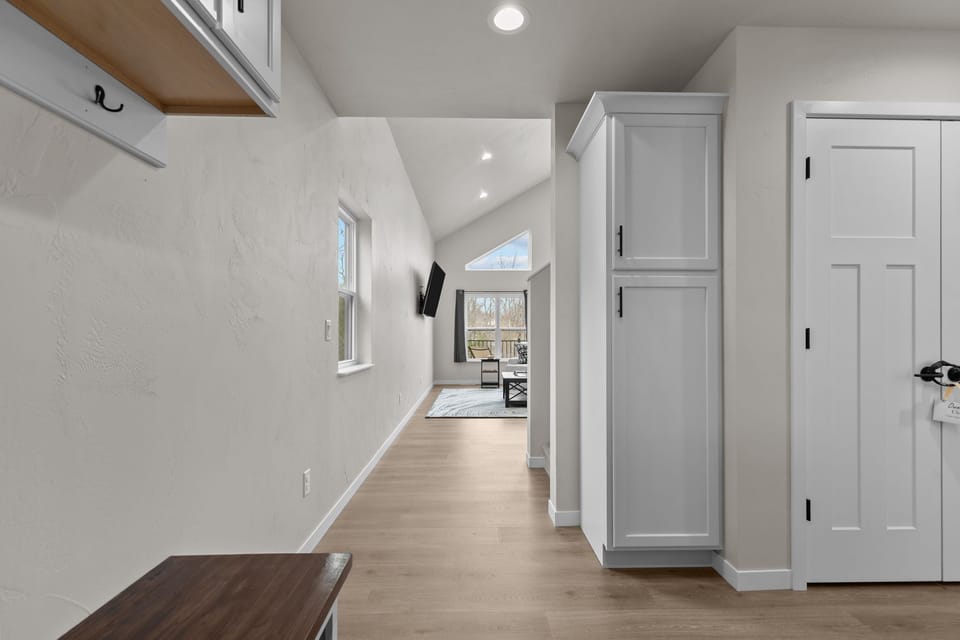 As you enter the home, a spacious hallway guides you from the entryway into the heart of the house—opening up to the bright and welcoming main living area where comfort and connection await.