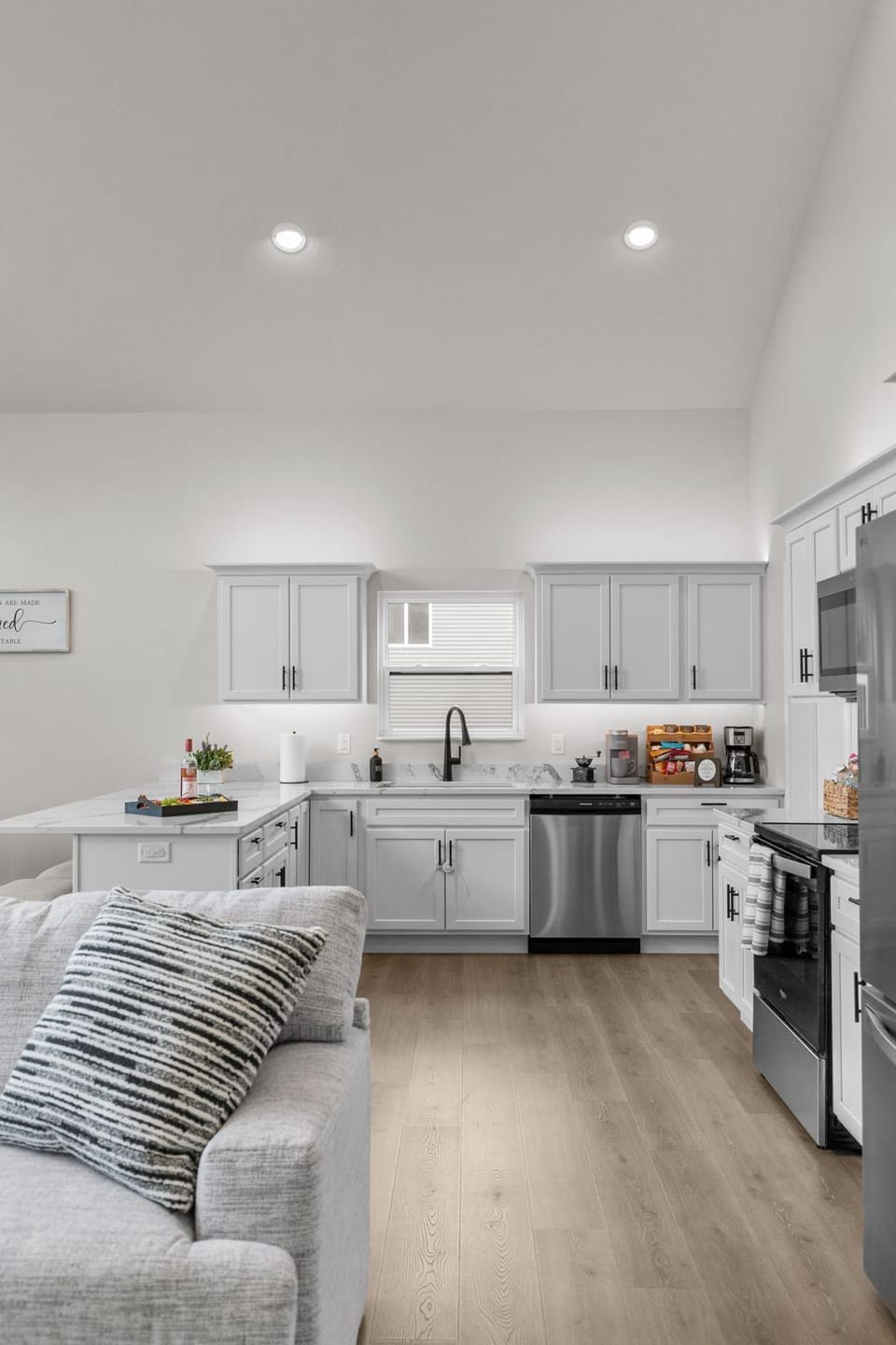 The kitchen is fully equipped with all the essentials, including a refrigerator and freezer with an ice maker, an electric stove, microwave, and dishwasher—everything you need to make mealtime easy and enjoyable.