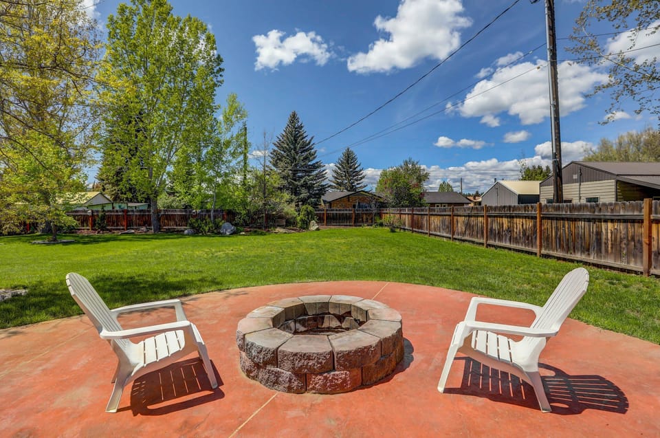 Large backyard with a fire pit and lawn area
