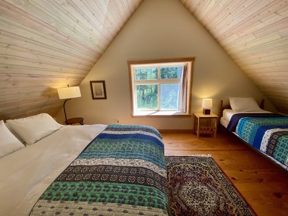 Like the pitched attic ceiling you see in story books, this room is perfect for families with children and features a queen and twin-sized bed. 