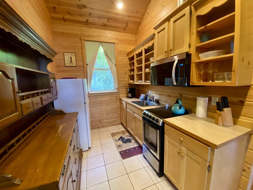 Put on the kettle in this cabin kitchen that is just right for preparing meals inside.