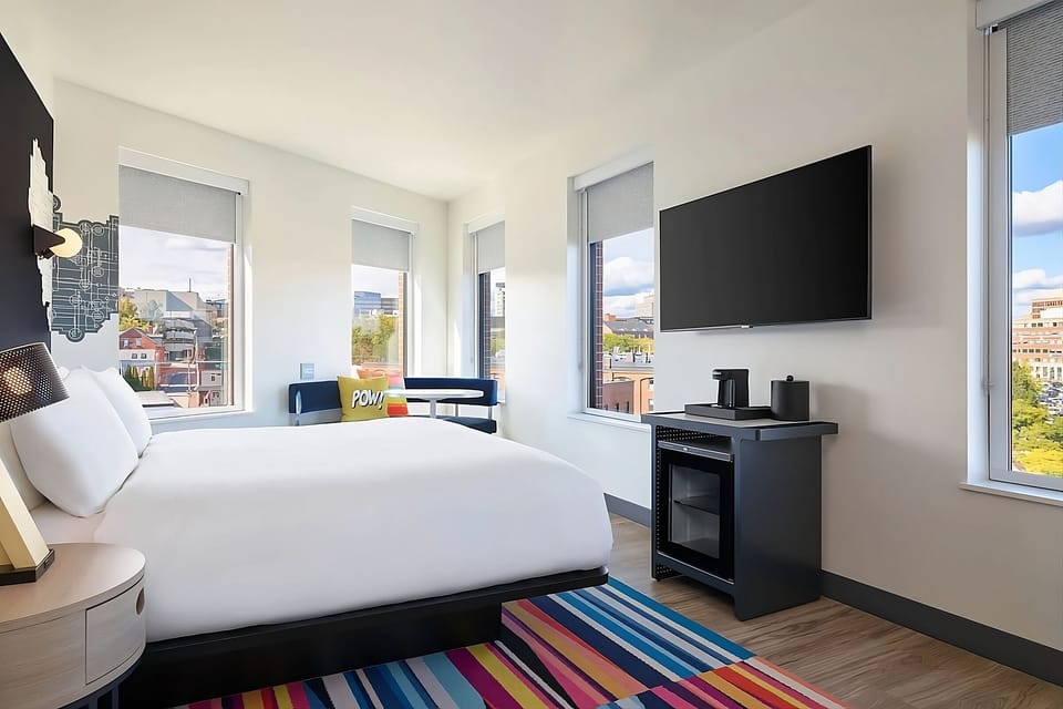 Unwind in crisp linens with sunny corner city views.