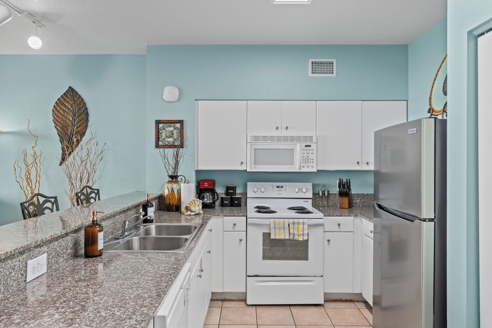 Full kitchen with modern appliances and tropical charm.