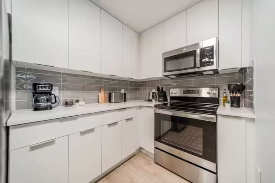 Cook with ease in this well-equipped kitchen featuring stainless steel appliances, ample cabinetry, and a stylish backsplash. Whether you`re brewing coffee or preparing a gourmet meal, this space is designed for functionality and style, making every meal